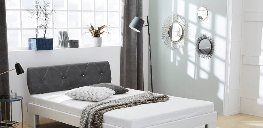 Bett im Schlafzimmer mit Lampen und Dekoration im Zimmer