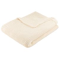 Gefaltete cremefarbene Decke in Waffelmuster auf weißem Hintergrund