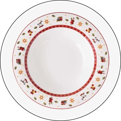 Weißer Teller mit roten und goldenen Weihnachtsmotiven am Rand, darunter Sterne, Spielzeugzüge, Schneemänner und Weihnachtsbäume.