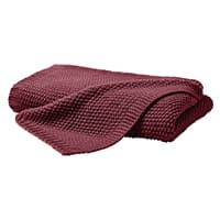 Gefaltete weinrote Decke mit grobem Strickmuster.