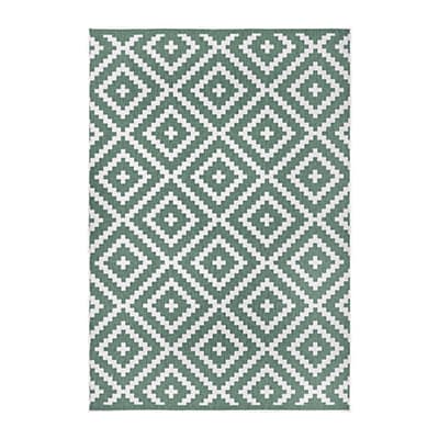 Rechteckiger Teppich mit dichtem Rautenmuster in Grün und Weiß, kleine Kreuze in der Mitte jeder Raute