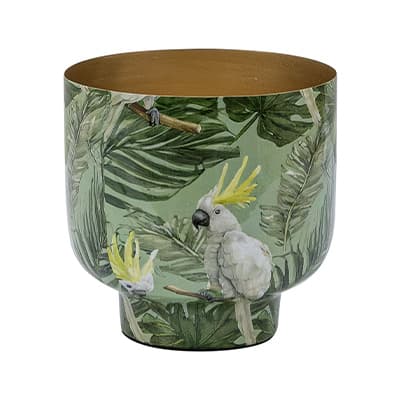 Runder Übertopf mit grünem Blattmuster und weißen Kakadus mit gelber Haube vor tropischem Hintergrund