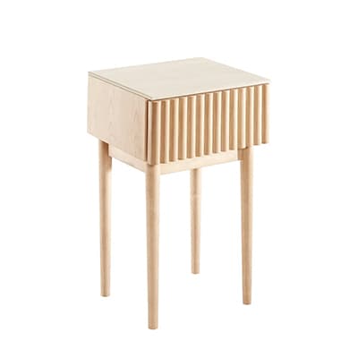 Heller Beistelltisch mit schmalen, hohen Beinen und geriffelter Front vor weißem Hintergrund