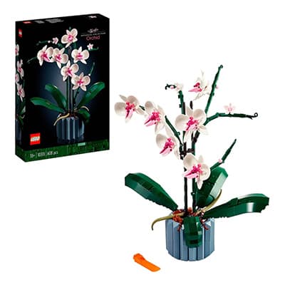 LEGO Orchidee Set mit weiß-rosa Blüten in rundem Topf, daneben die schwarze Produktverpackung