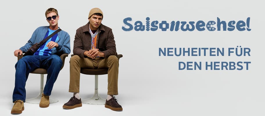 Saisonwechsel – Neuheiten für den Herbst, zwei Männer in herbstlicher Mode sitzen nebeneinander auf Stühlen