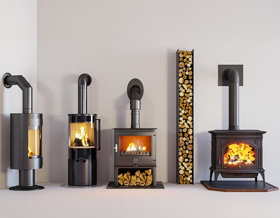 Vier moderne Kaminöfen in Reihe – Holzscheite in schlankem Regal rechts – alle Öfen brennen mit hellem, sichtbarem Feuer