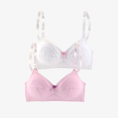 Zwei schlichte BHs übereinander, vorne rosa mit Schleife, dahinter weißer BH mit Schleife